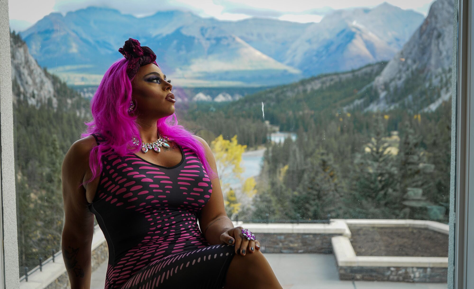 A drag performer sits in a window in the Vermilion Room at the Banff Springs Hotel in Banff National Park.